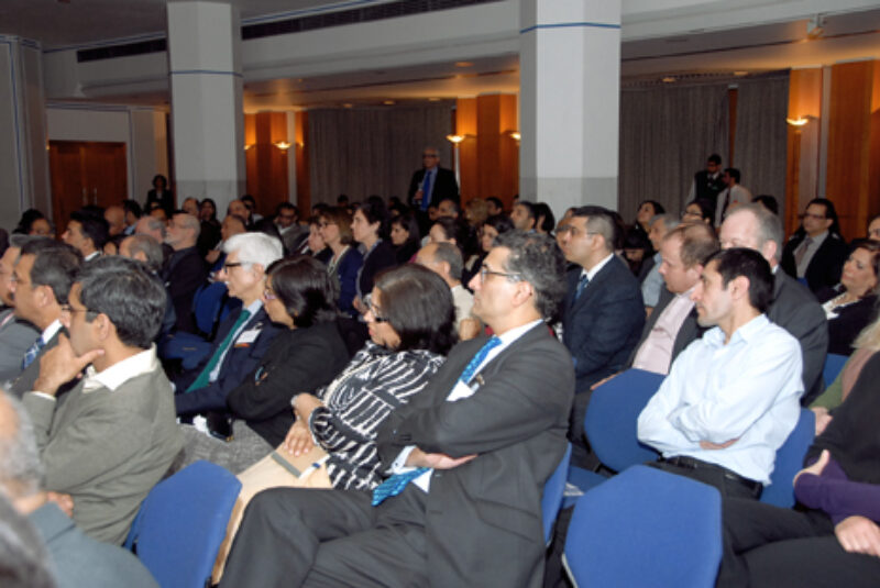 A group of people sitting and listening to a session