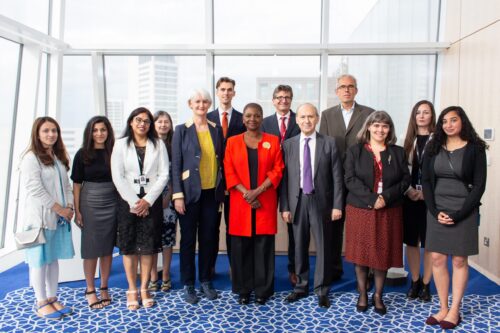 A group of formally dressed people posing for a picture