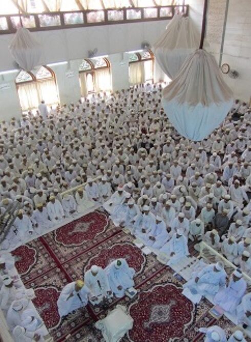 A group of people recited prayers in a prayer hall