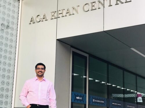 A STEP student posing near the entrance of the AgaKhan Centre