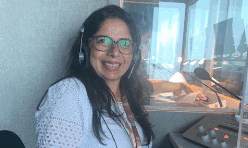 STEP student from C14 wearing a headset in a studio and posing.