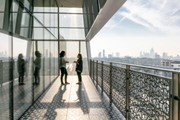 A far sighted image of two women talking in the corridor balcony at Aga Khan Centre (AKC)