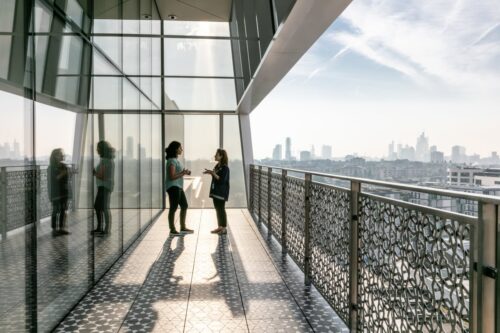 A far sighted image of two women talking in the corridor balcony at Aga Khan Centre (AKC)