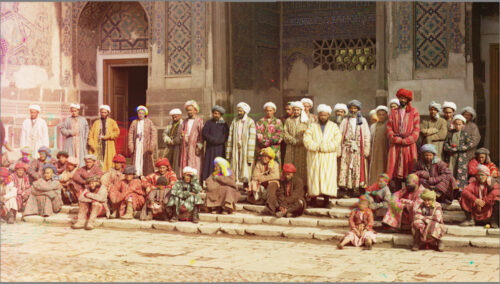 An Ivanow gallery colourful image with a group of people in Arab dressing standing near a Muslim monument in Adab (respectful) gesture