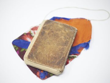A book from the IIS archive placed over a colourful piece of cloth