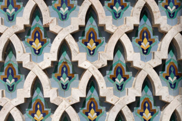 A series of flower patterns carved on a wall of stone