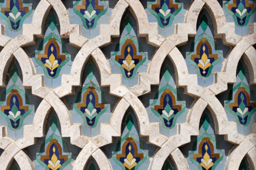 A series of flower patterns carved on a wall of stone