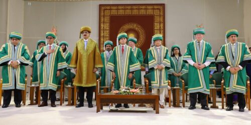 Princess Zahra, IIS Board of Governors, faculties and students all standing in respect in two rows wearing AKU graduation gowns