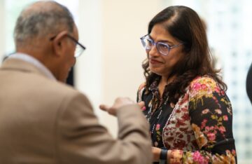 Dr. Laila Halani speaking to an IIS representative during the welcome lunch event 2023