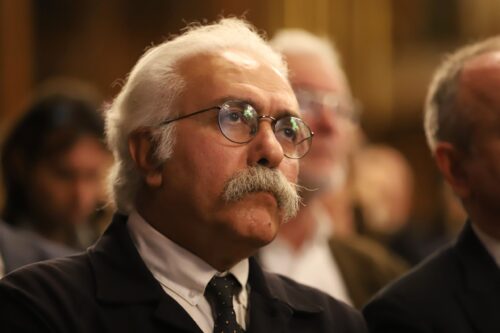Prof. Mohammad Ali Amir-Moezzi sitting in an inauguration ceremony for his appointment as Chevalier at Institut Français Islamologie