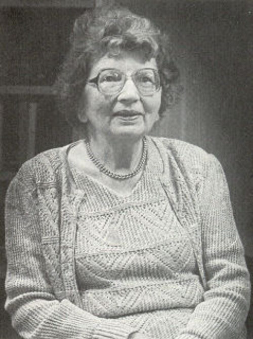 A black and white image of Annemarie Schimmel sitting and posing, taken around the middle aged era of her life