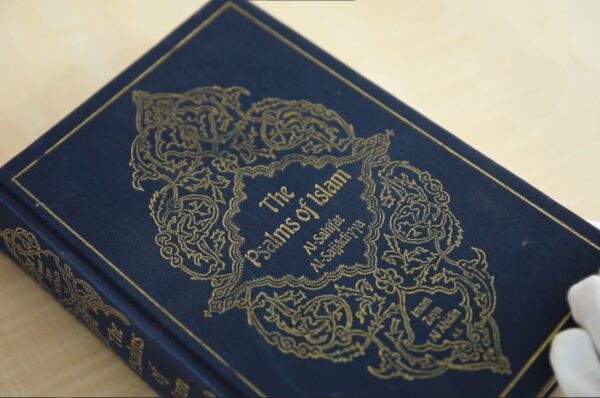 Book cover with blue colour and text reading The Psalms of Islam al-Sahifa al-Sajjadiyya, on a yellow backgroubnd
