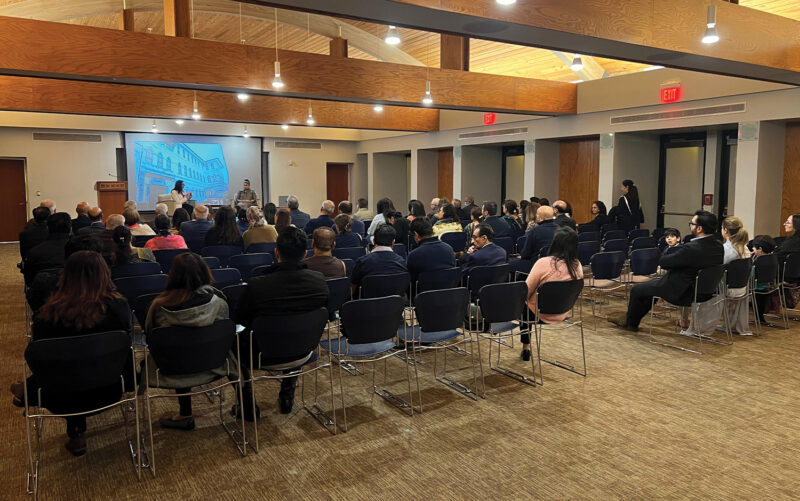 Jamati members watching Dr Remtilla's presentation