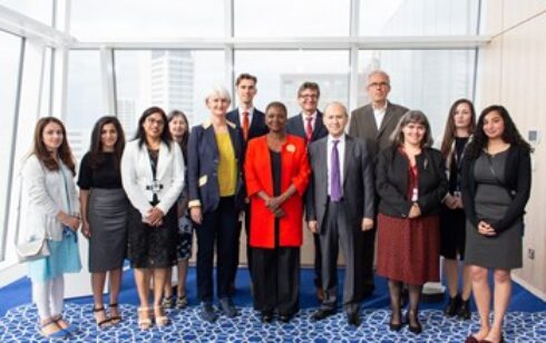 A group of formally dressed people posing for a picture
