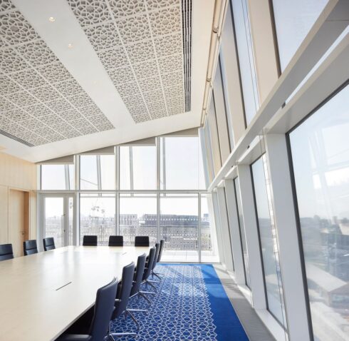 An image of an empty executive meeting room at Aga Khan Centre with a round table and some chairs lying around it