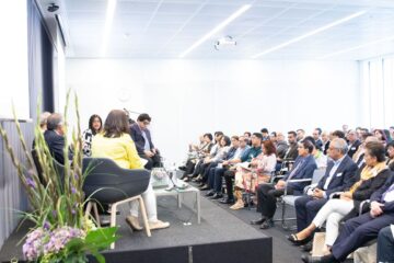 A group of IIS staff sitting at the podium discussing and addressing the audience at AKC