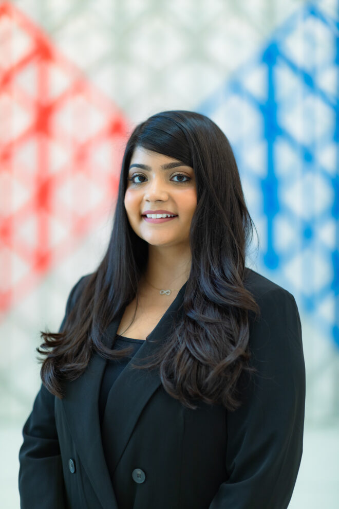 Nausheen Hoosein in a black suit posing for a picture