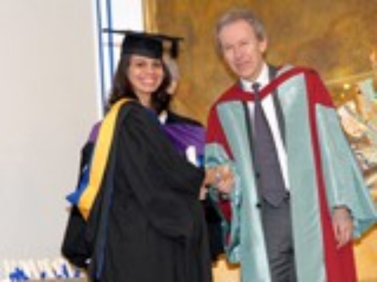 A student receiving award from the scholar Dr. Farhad Daftary