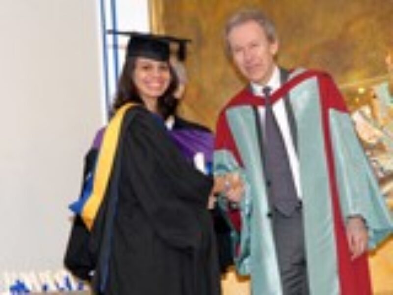 A student receiving award from the scholar Dr. Farhad Daftary