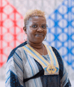 Shola Ajilore posing for a photo in the AKC background