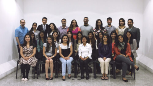 A group of people standing in three rows, first two rows sitting and the rest standing