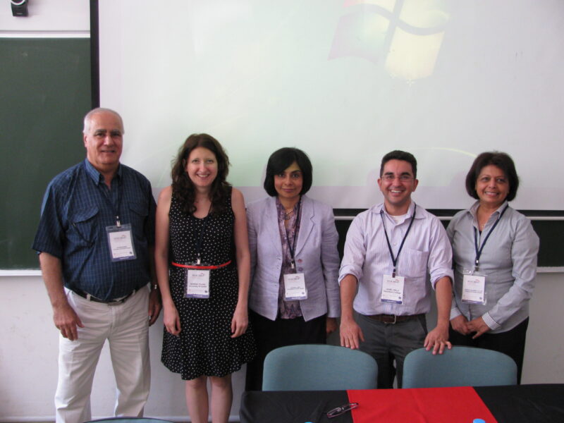 A group of people posing for a photo with a white screen in the background